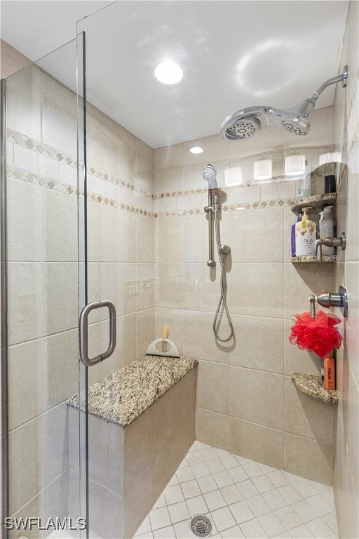 bathroom with a shower with door