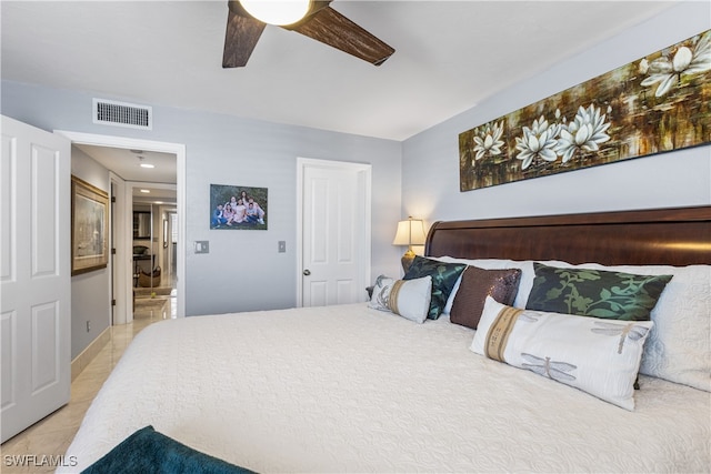 tiled bedroom featuring ceiling fan