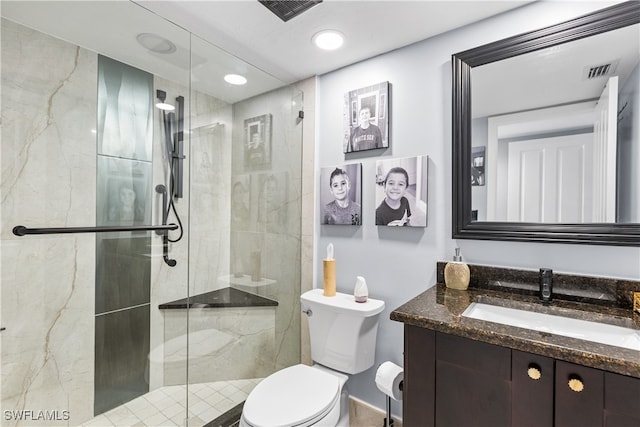 bathroom featuring toilet, an enclosed shower, and vanity