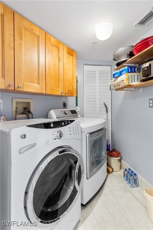 laundry room featuring cabinets and independent washer and dryer