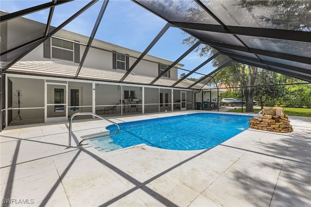 view of swimming pool featuring a patio and glass enclosure