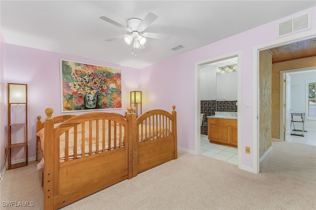 carpeted bedroom featuring ensuite bathroom and ceiling fan