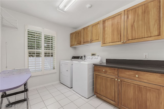 laundry area with cabinets, independent washer and dryer, and light tile patterned floors