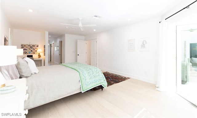 bedroom featuring ceiling fan, wood-type flooring, and ensuite bathroom