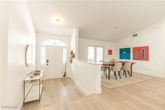 entrance foyer featuring light hardwood / wood-style flooring and lofted ceiling