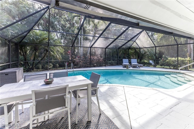 view of swimming pool with a lanai and a patio