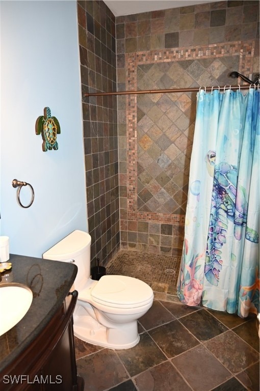 bathroom with vanity, toilet, and curtained shower