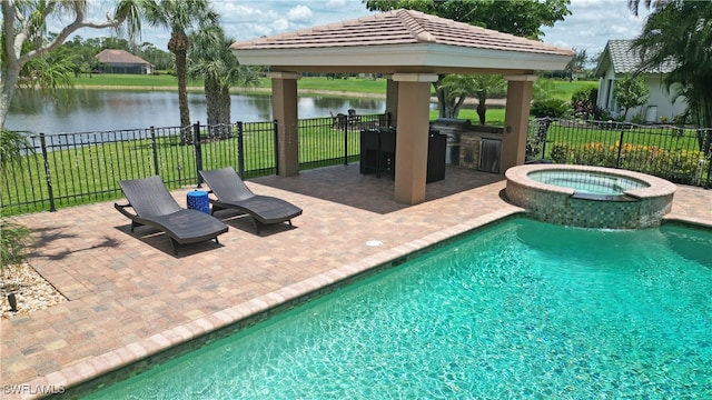 view of swimming pool with a water view, an in ground hot tub, a yard, and a patio