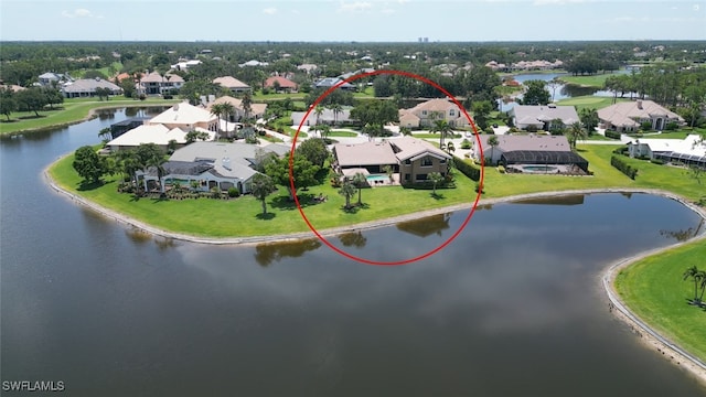 birds eye view of property with a water view