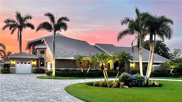 view of front of home featuring a lawn and a garage