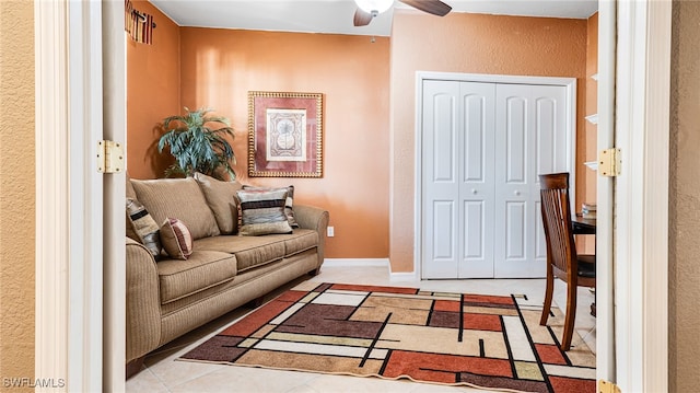 tiled living room featuring ceiling fan