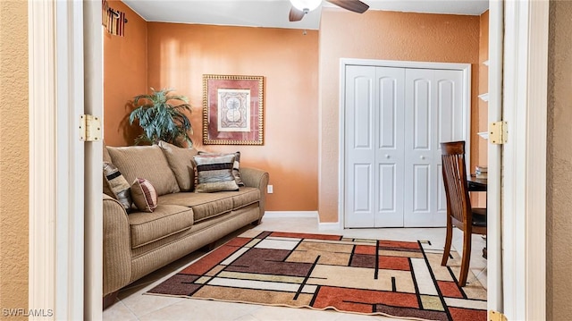 14801 Reflection Key Cir Unit 212, Fort Myers, FL 33907 - living area featuring ceiling fan, a textured wall, and tile patterned floors