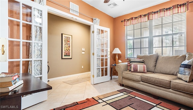 tiled living room featuring ceiling fan