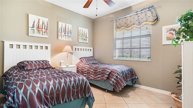 bedroom with ceiling fan and light tile patterned floors