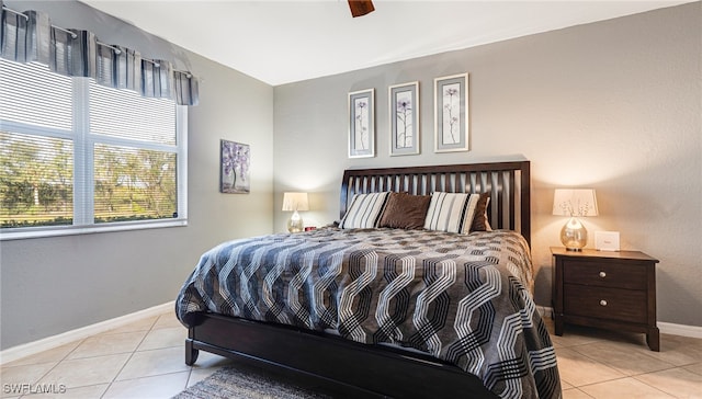 tiled bedroom featuring ceiling fan