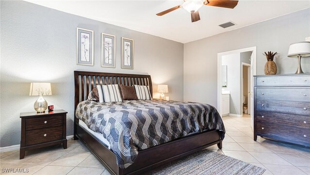 14801 Reflection Key Cir Unit 212, Fort Myers, FL 33907 - bedroom featuring tile patterned floors, ensuite bath, baseboards, and a ceiling fan