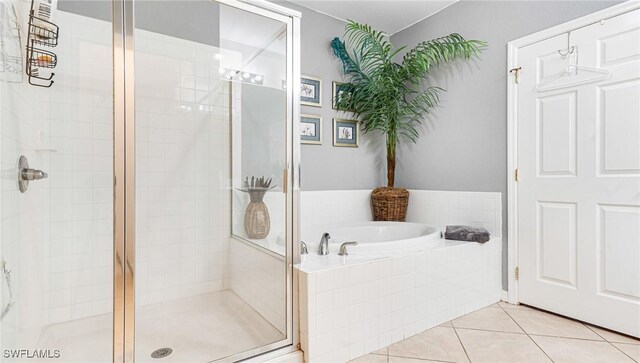 14801 Reflection Key Cir Unit 212, Fort Myers, FL 33907 - full bathroom featuring a stall shower, a bath, and tile patterned floors