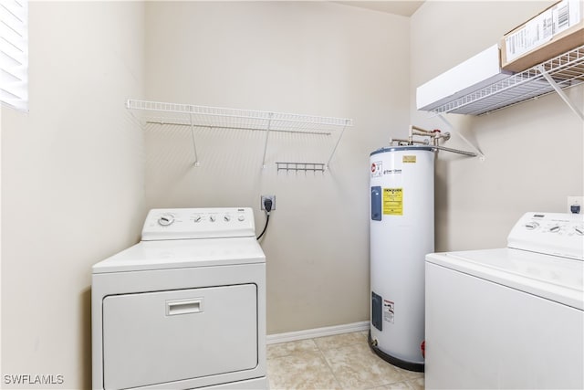 clothes washing area with water heater, light tile patterned floors, and independent washer and dryer