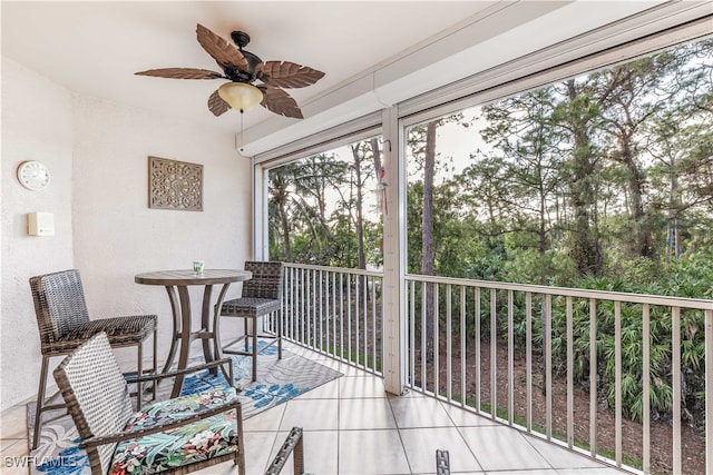 sunroom / solarium featuring ceiling fan