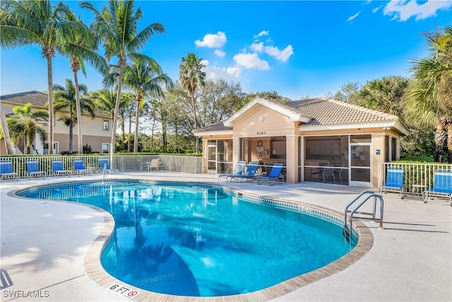 view of pool with a patio and a sunroom