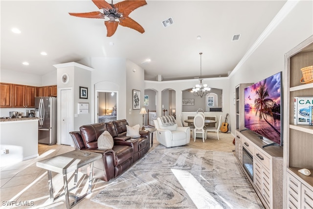 tiled living room with ceiling fan with notable chandelier and ornamental molding