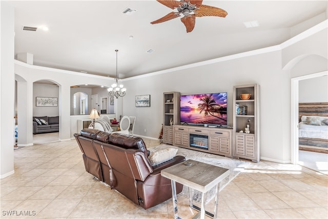 tiled living room with ceiling fan with notable chandelier, crown molding, and lofted ceiling