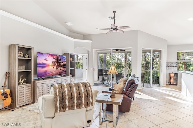 living room featuring ceiling fan, plenty of natural light, light tile patterned flooring, and vaulted ceiling