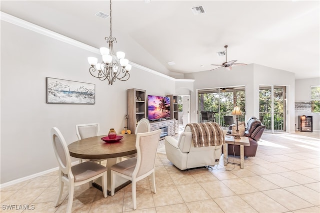 dining area with ceiling fan with notable chandelier, lofted ceiling, crown molding, and light tile patterned floors