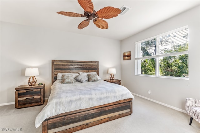 bedroom with ceiling fan and light carpet