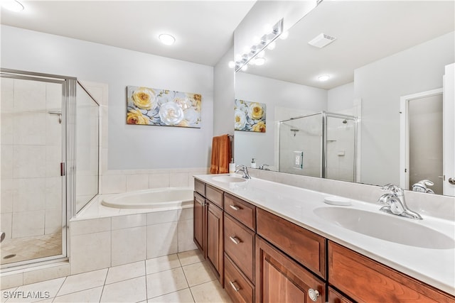 bathroom featuring tile patterned flooring, shower with separate bathtub, and vanity