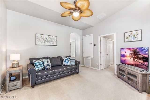 living room featuring ceiling fan, light colored carpet, and vaulted ceiling