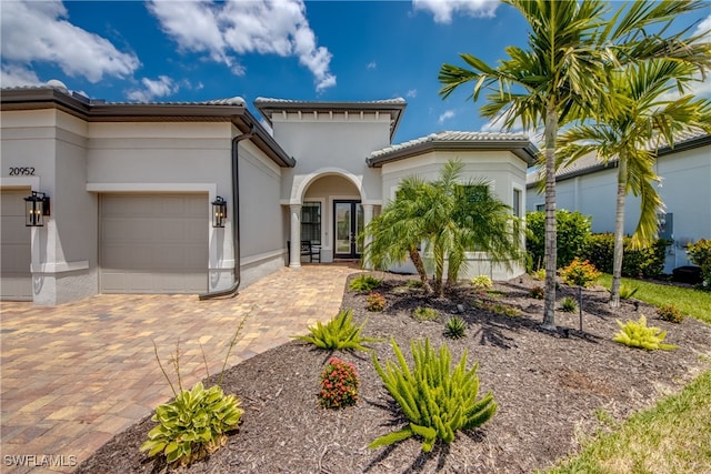 mediterranean / spanish-style house with a garage