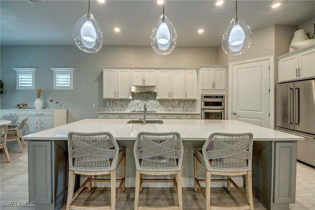 kitchen with a spacious island, stainless steel appliances, and pendant lighting