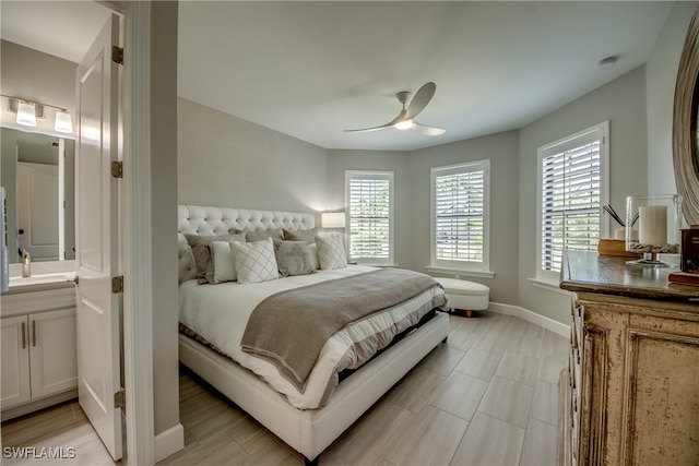 bedroom with ensuite bath and ceiling fan