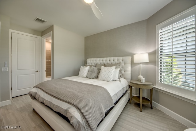 bedroom featuring ceiling fan and ensuite bathroom