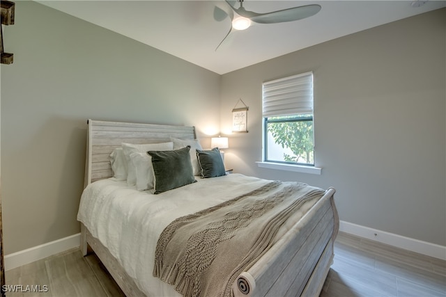 bedroom with light hardwood / wood-style floors and ceiling fan