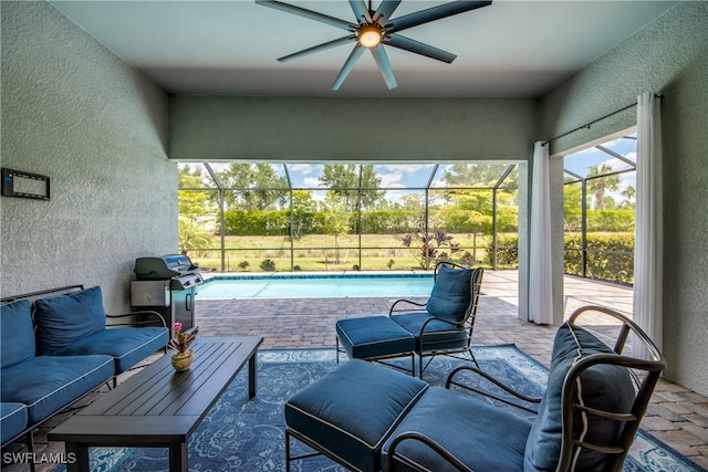 view of swimming pool featuring a patio, area for grilling, ceiling fan, and glass enclosure