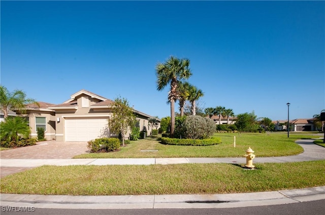 view of front of house featuring a garage and a front lawn