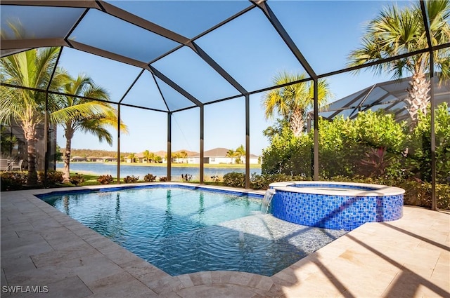 view of pool with an in ground hot tub, pool water feature, a water view, glass enclosure, and a patio