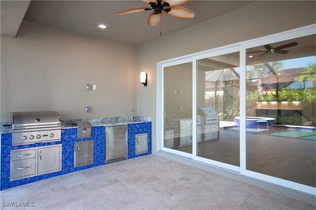 view of patio / terrace featuring an outdoor kitchen, ceiling fan, and grilling area