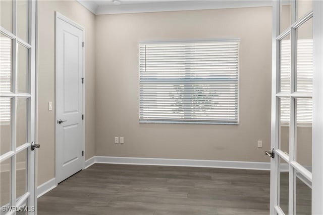 empty room with dark wood-type flooring and french doors