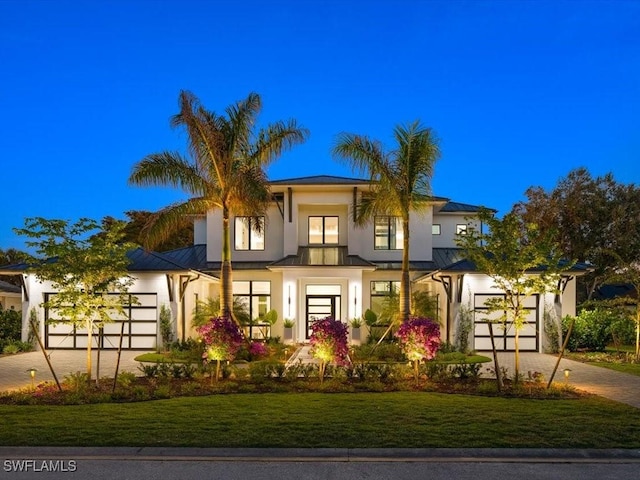 view of front facade with a front yard and a garage