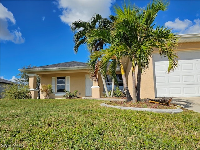 view of front of property with a front yard and a garage