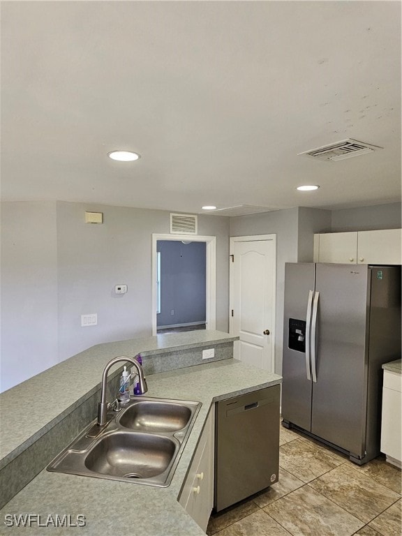 kitchen with white cabinetry, stainless steel appliances, and sink