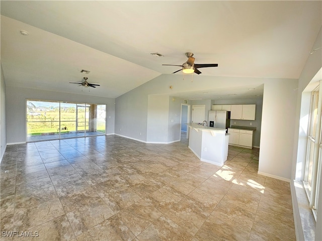 unfurnished living room featuring ceiling fan and vaulted ceiling