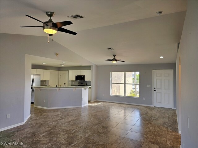 unfurnished living room with lofted ceiling and ceiling fan