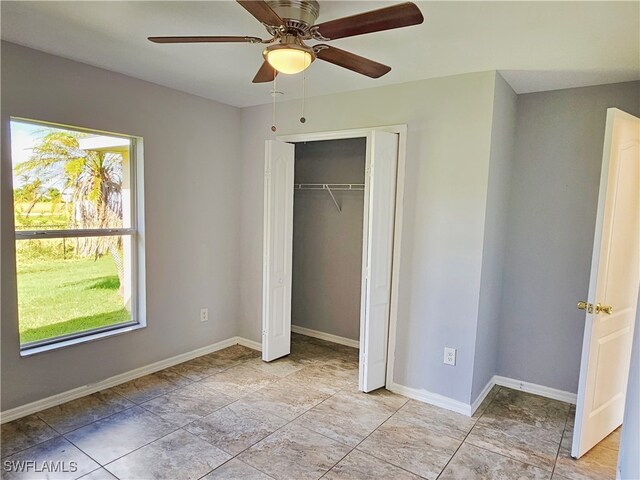 unfurnished bedroom with a closet and ceiling fan