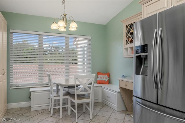 dining area featuring baseboards, marble finish floor, and an inviting chandelier