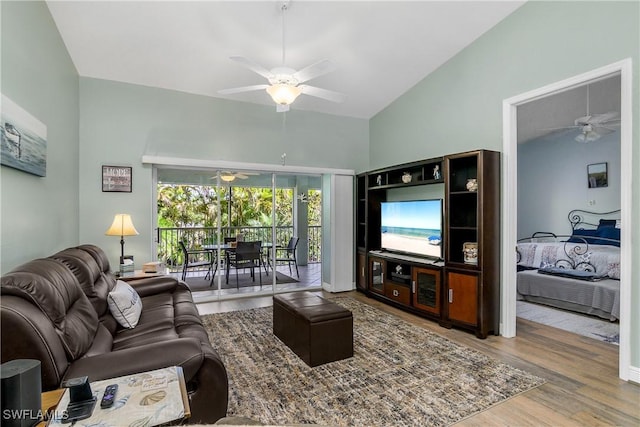 living area with lofted ceiling, a ceiling fan, and wood finished floors