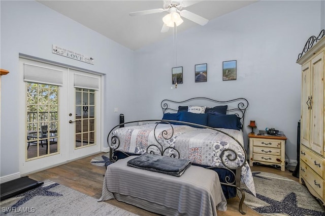 bedroom featuring lofted ceiling, wood finished floors, baseboards, access to exterior, and french doors